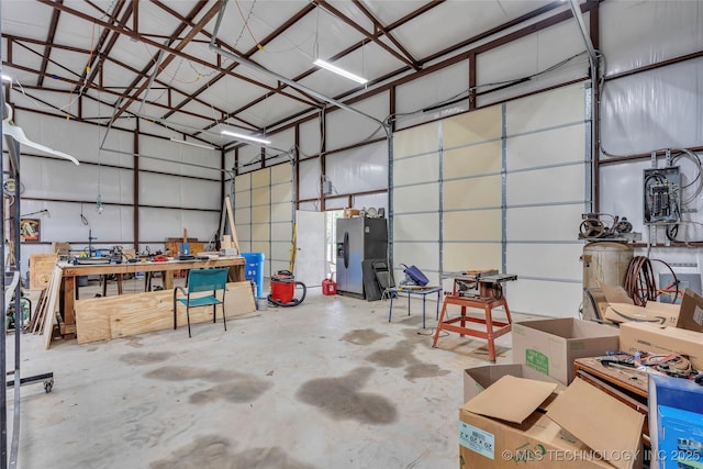 garage featuring stainless steel refrigerator with ice dispenser
