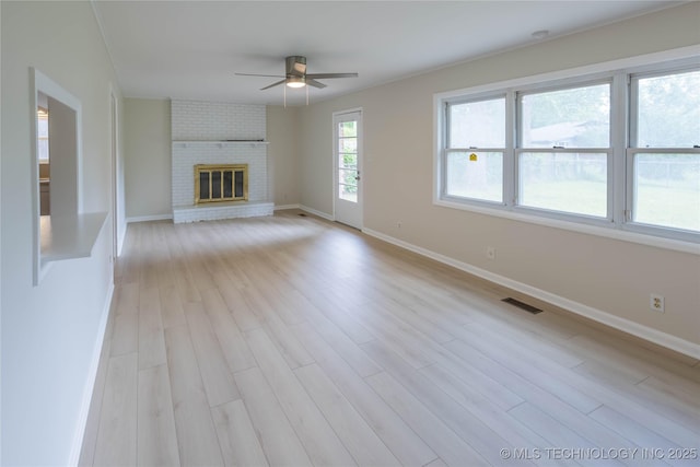 unfurnished living room featuring a ceiling fan, baseboards, visible vents, and light wood-type flooring