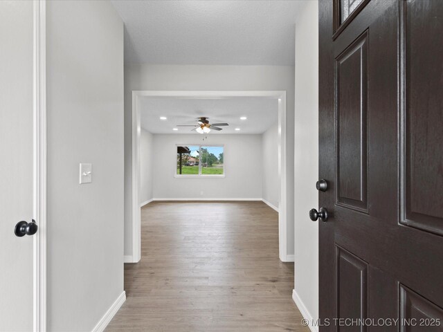 entryway featuring a ceiling fan, baseboards, recessed lighting, and wood finished floors