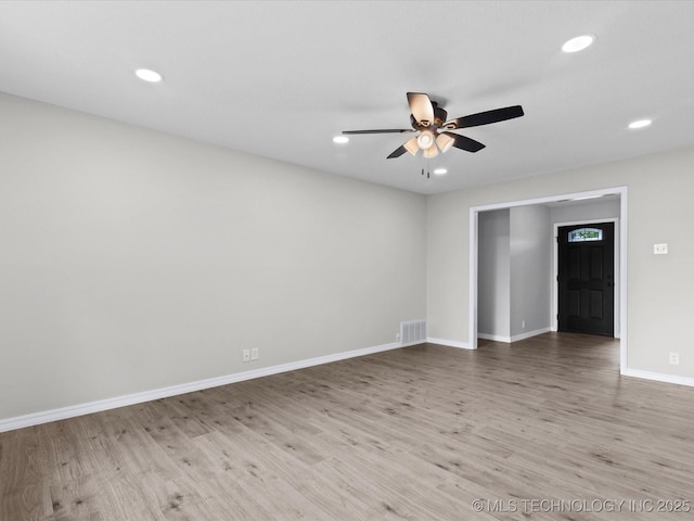 empty room with visible vents, wood finished floors, baseboards, ceiling fan, and recessed lighting
