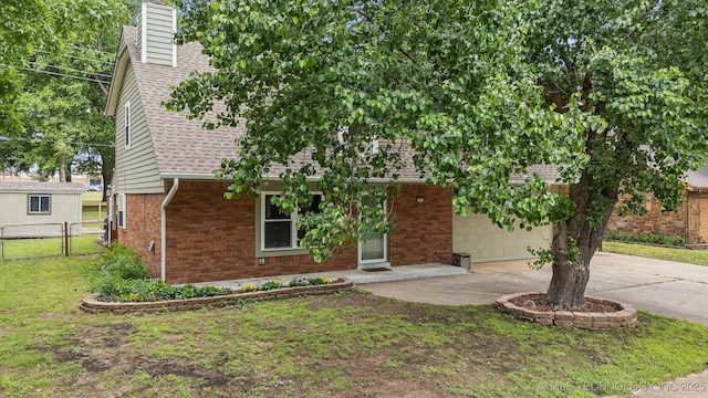 6605 S 1st St, Broken Arrow, OK 74012 - view of front of property with brick siding, concrete driveway, a garage, roof with shingles, and a chimney