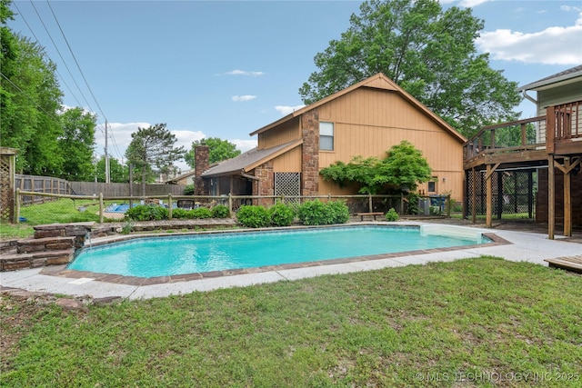 view of swimming pool featuring a fenced backyard, a fenced in pool, a yard, and a deck