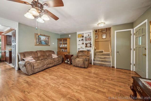 6605 S 1st St, Broken Arrow, OK 74012 - living area with light wood-type flooring, ceiling fan, stairway, and built in features