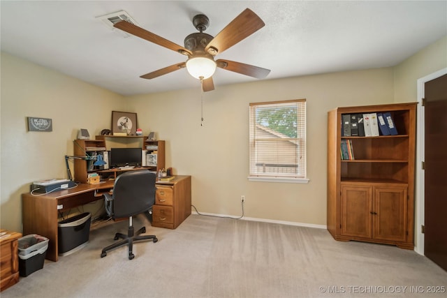 office with baseboards, a ceiling fan, and light carpet