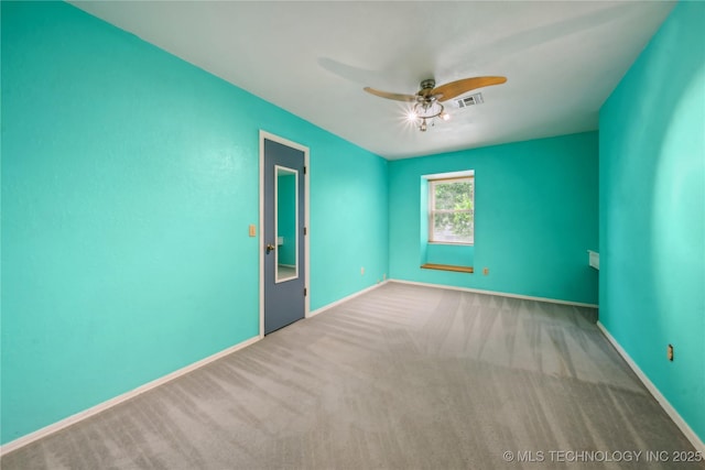 unfurnished room featuring carpet floors, baseboards, ceiling fan, and visible vents