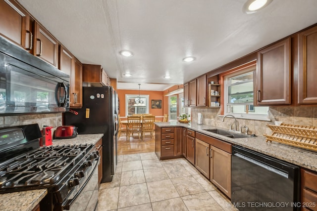 6605 S 1st St, Broken Arrow, OK 74012 - kitchen featuring black appliances, backsplash, light stone countertops, a peninsula, and recessed lighting