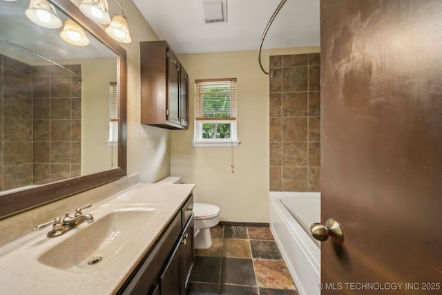 6605 S 1st St, Broken Arrow, OK 74012 - full bath featuring vanity, stone tile floors, and washtub / shower combination
