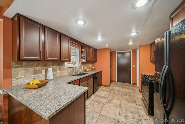 kitchen featuring backsplash, recessed lighting, a sink, and black appliances
