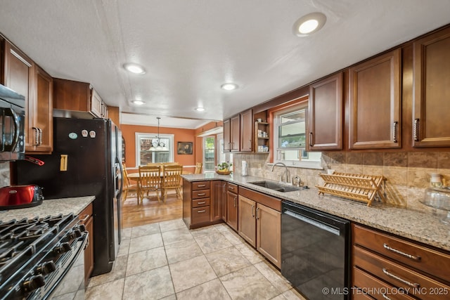 6605 S 1st St, Broken Arrow, OK 74012 - kitchen featuring stainless steel appliances, backsplash, brown cabinets, light stone countertops, and open shelves