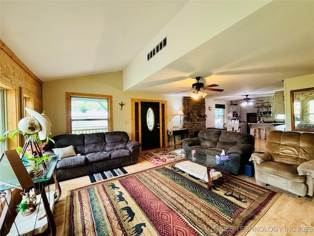 living area with visible vents, a ceiling fan, wood finished floors, and a wealth of natural light