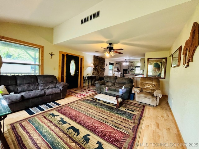 living area featuring ceiling fan, wood finished floors, and visible vents