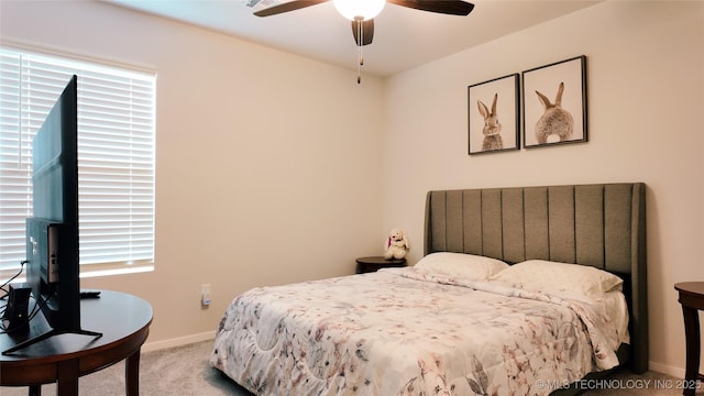 bedroom with carpet floors, a ceiling fan, and baseboards