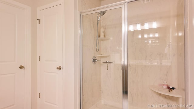 full bath with a marble finish shower