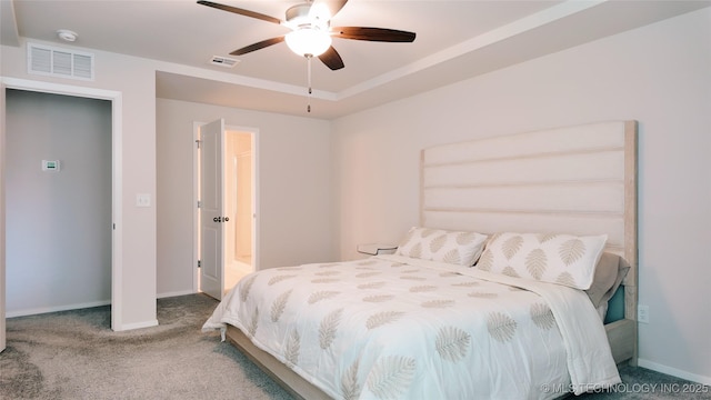 carpeted bedroom featuring visible vents, a ceiling fan, and baseboards