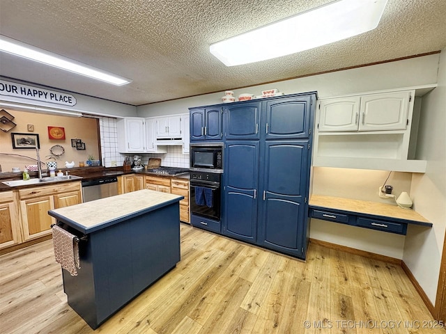 kitchen with light wood-style floors, blue cabinets, a textured ceiling, and black appliances