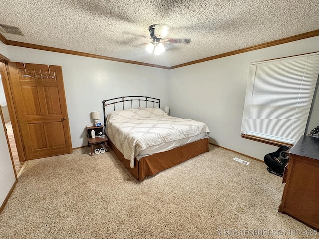 bedroom with crown molding, carpet floors, and visible vents