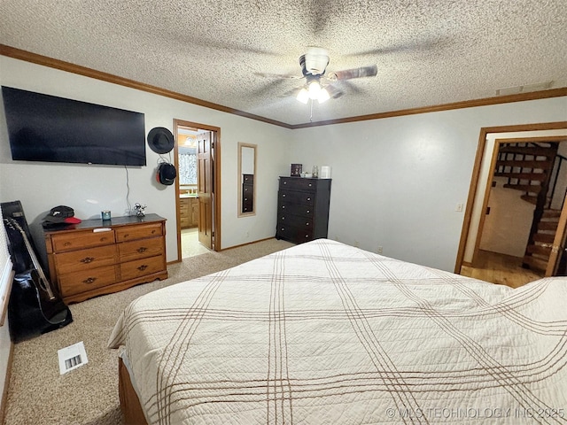 bedroom featuring crown molding, connected bathroom, a textured ceiling, and light colored carpet