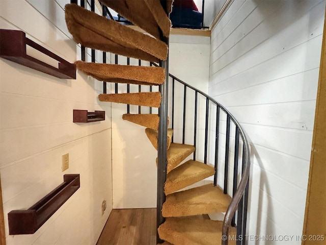 staircase with wood finished floors