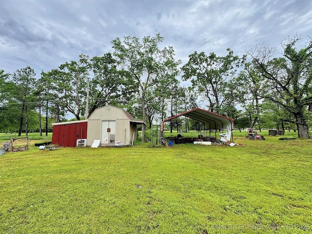 view of yard featuring a storage unit, a carport, and an outdoor structure