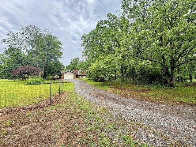 view of road with gravel driveway