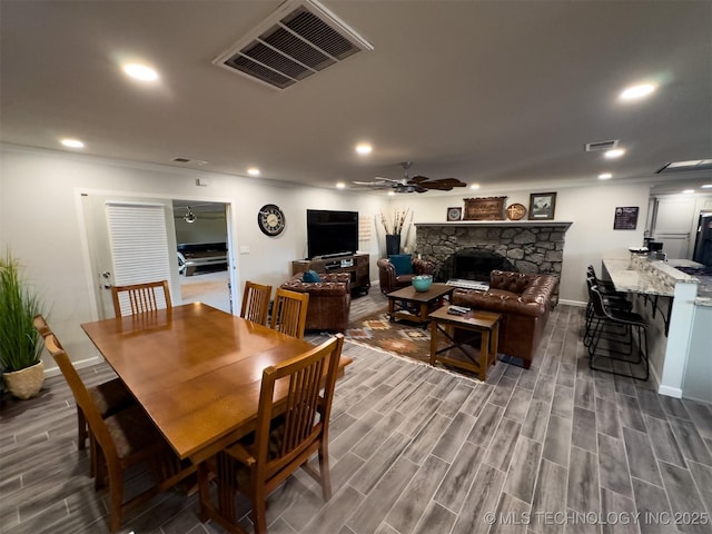 dining area featuring baseboards, a ceiling fan, wood finished floors, and visible vents
