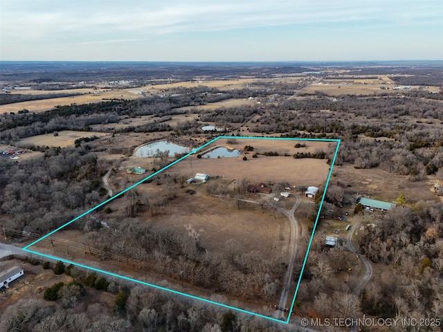 birds eye view of property featuring a rural view and a desert view