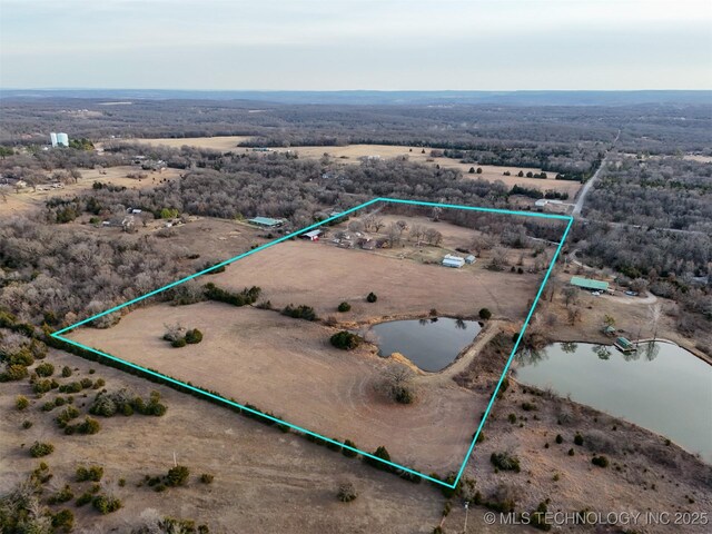 drone / aerial view featuring a water view, view of desert, and a rural view
