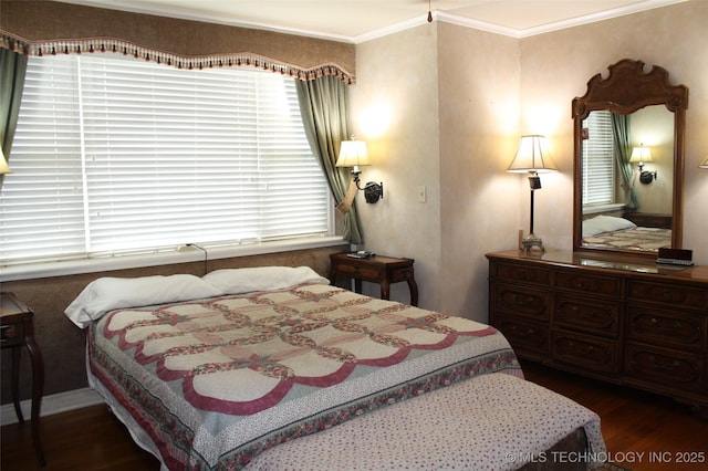 bedroom featuring crown molding and wood finished floors
