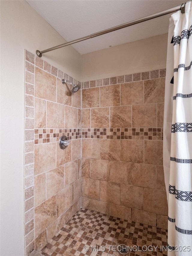 bathroom with tiled shower