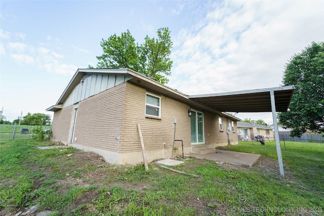 1160 S 124th E Ave, Tulsa, OK 74128 - rear view of property with board and batten siding and a patio area