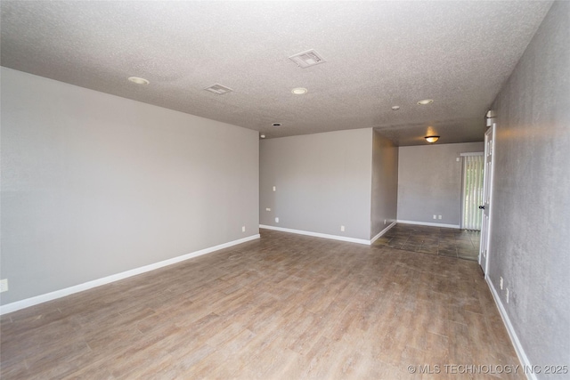 1160 S 124th E Ave, Tulsa, OK 74128 - empty room featuring wood finished floors, a textured ceiling, baseboards, and recessed lighting