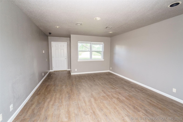 1160 S 124th E Ave, Tulsa, OK 74128 - empty room featuring wood finished floors, baseboards, a textured ceiling, and recessed lighting