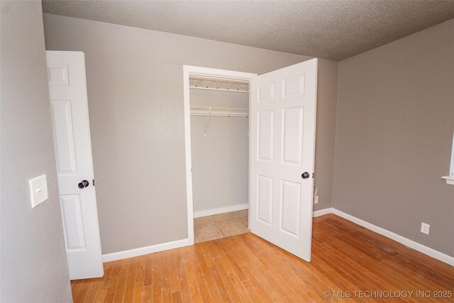 1160 S 124th E Ave, Tulsa, OK 74128 - unfurnished bedroom with a closet, light wood finished floors, and baseboards