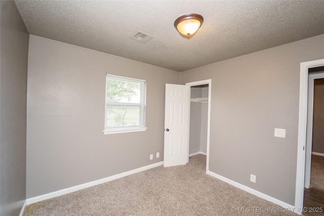 1160 S 124th E Ave, Tulsa, OK 74128 - unfurnished bedroom featuring carpet floors, a closet, baseboards, and a textured ceiling