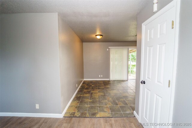 1160 S 124th E Ave, Tulsa, OK 74128 - hallway featuring a textured ceiling and baseboards
