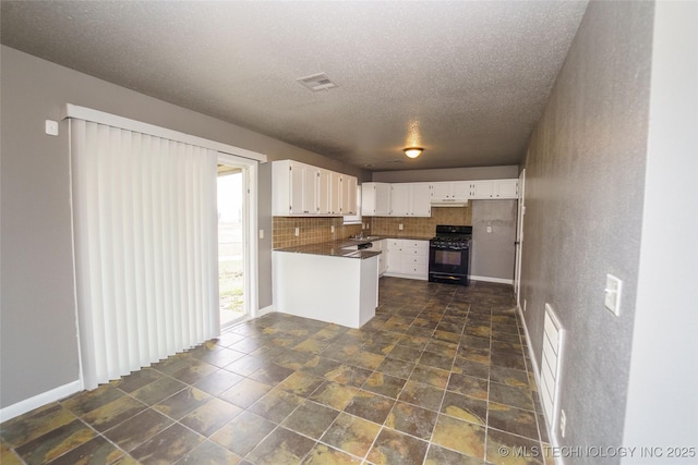1160 S 124th E Ave, Tulsa, OK 74128 - kitchen featuring black gas stove, a peninsula, white cabinets, dark countertops, and a textured ceiling