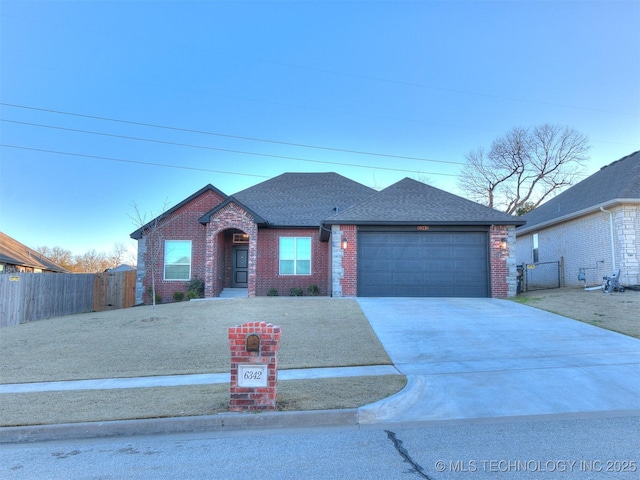 6342 E 148th St S, Bixby, OK 74008 - view of front of property featuring brick siding, an attached garage, driveway, roof with shingles, and a gate