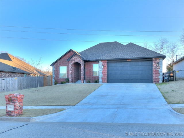 6342 E 148th St S, Bixby, OK 74008 - view of front of property with roof with shingles, brick siding, driveway, and a garage