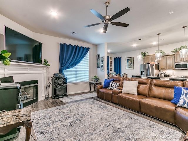 6342 E 148th St S, Bixby, OK 74008 - living room featuring ceiling fan, wood finished floors, baseboards, and a fireplace