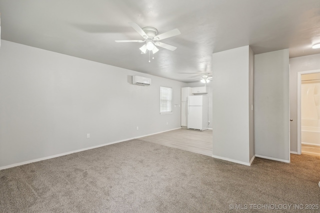 unfurnished living room with carpet floors, a ceiling fan, baseboards, and a wall unit AC