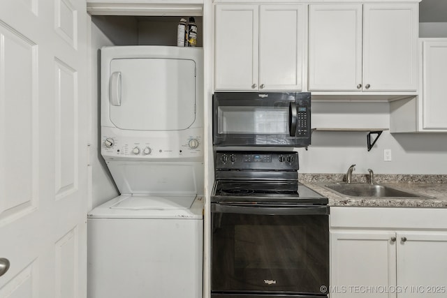 clothes washing area with laundry area, a sink, and stacked washing maching and dryer