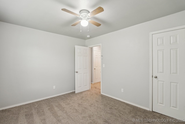 unfurnished bedroom with carpet flooring, a ceiling fan, and baseboards