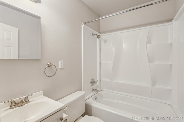 bathroom featuring vanity, washtub / shower combination, and toilet
