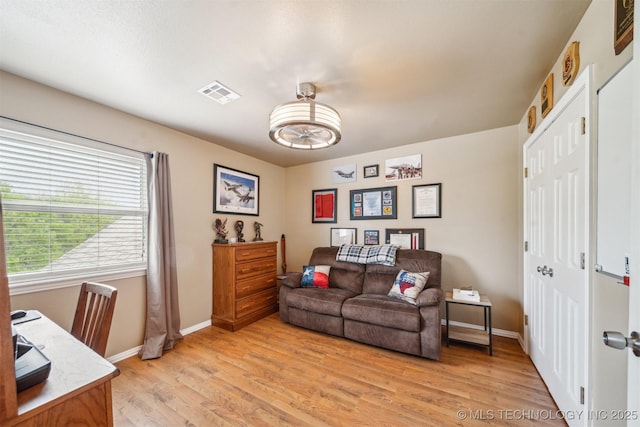 home office with light wood-type flooring, baseboards, and visible vents