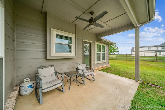 view of patio featuring ceiling fan and fence