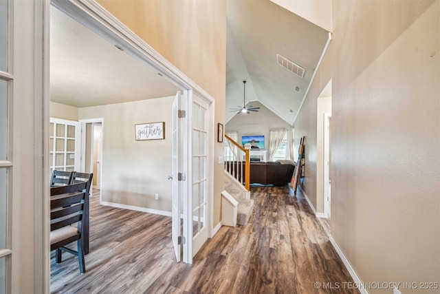 interior space featuring stairs, french doors, visible vents, and wood finished floors