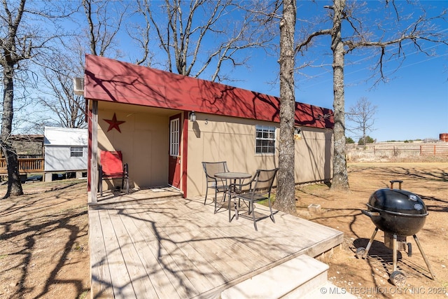 exterior space with fence and an outbuilding