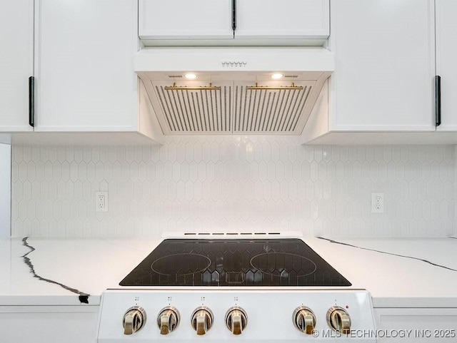 details with backsplash, light countertops, cooktop, ventilation hood, and white cabinetry