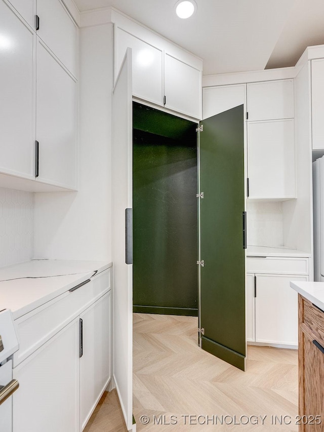 kitchen with light countertops, recessed lighting, and white cabinetry