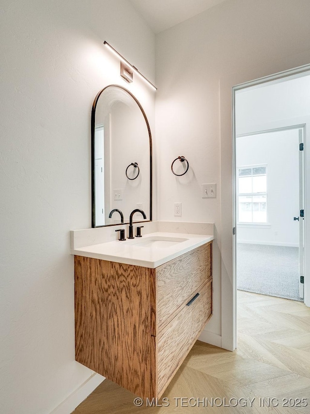 bathroom featuring vanity and baseboards